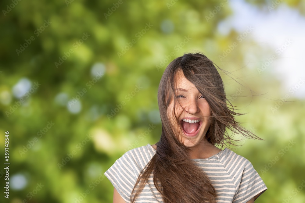 Happy young beautiful woman posing on outdoor background Happy young beautiful woman posing on outdoor background