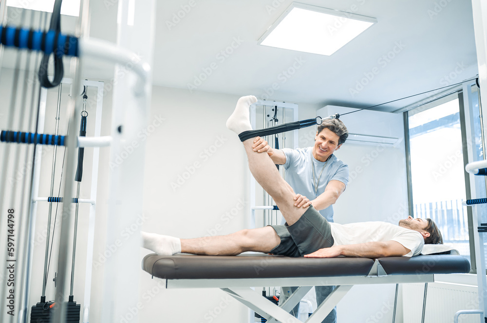 Physal therapist working with patients limb hyperextension Physal therapist working with patients limb hyperextension