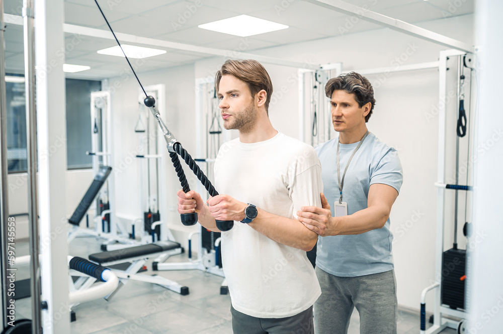 Man having a workout in a gym in a rehabilitation center Man having a workout in a gym in a rehabilitation center