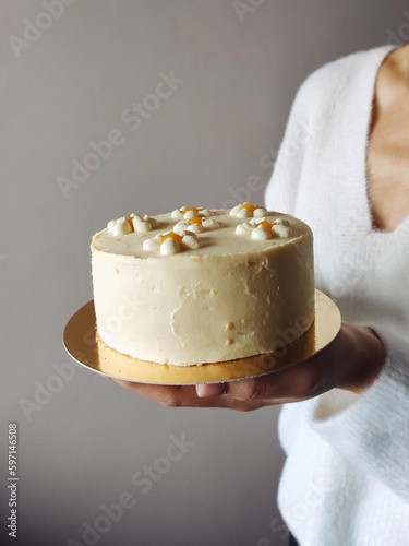 girl holding a cake with cream (ID: 597146508)