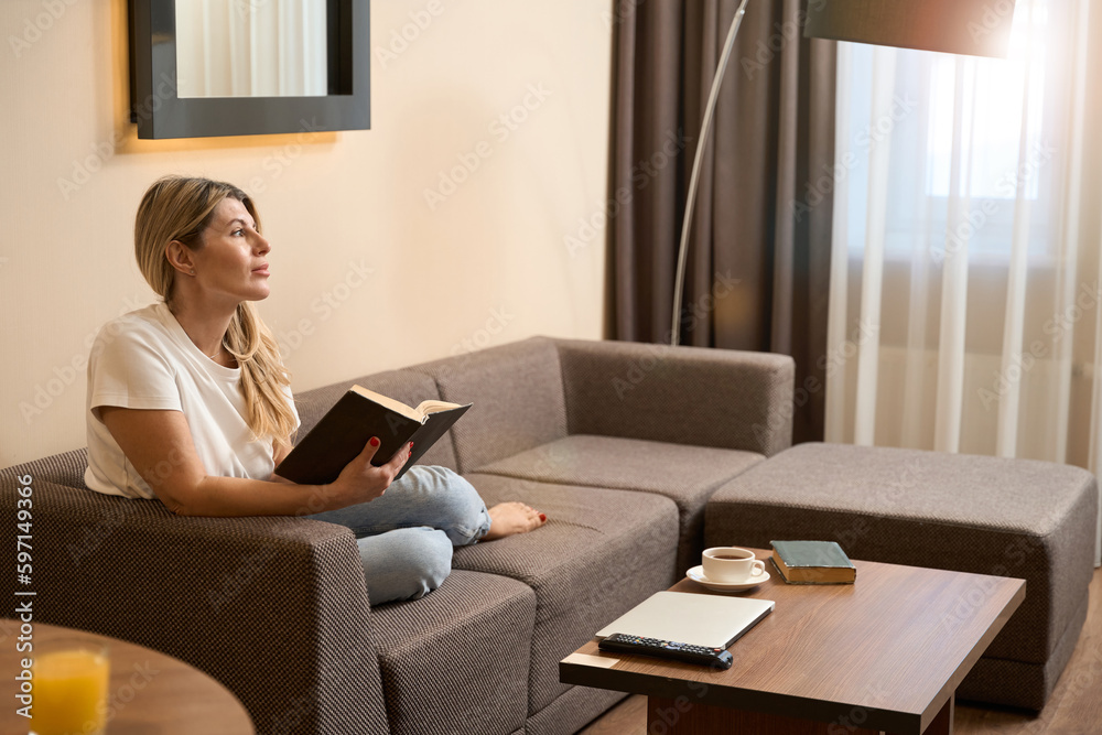 Young female relaxing on sofa at home Young female relaxing on sofa at home