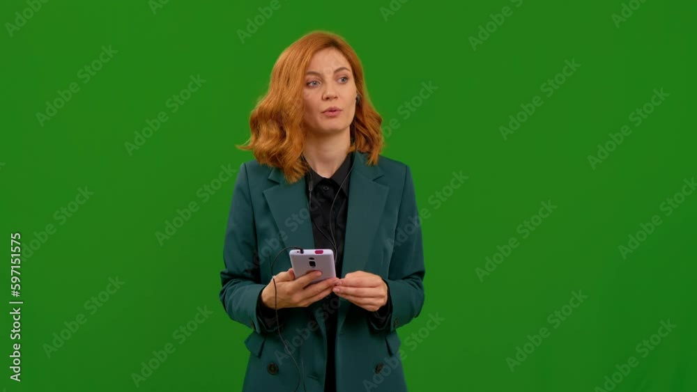 Serious woman wearing headset while working in freelance. Support service operator helpline having talk with client or colleague. Female on green chroma key background. Serious woman wearing headset while working in freelance. Support service operator helpline having talk with client or colleague. Female on green chroma key background.