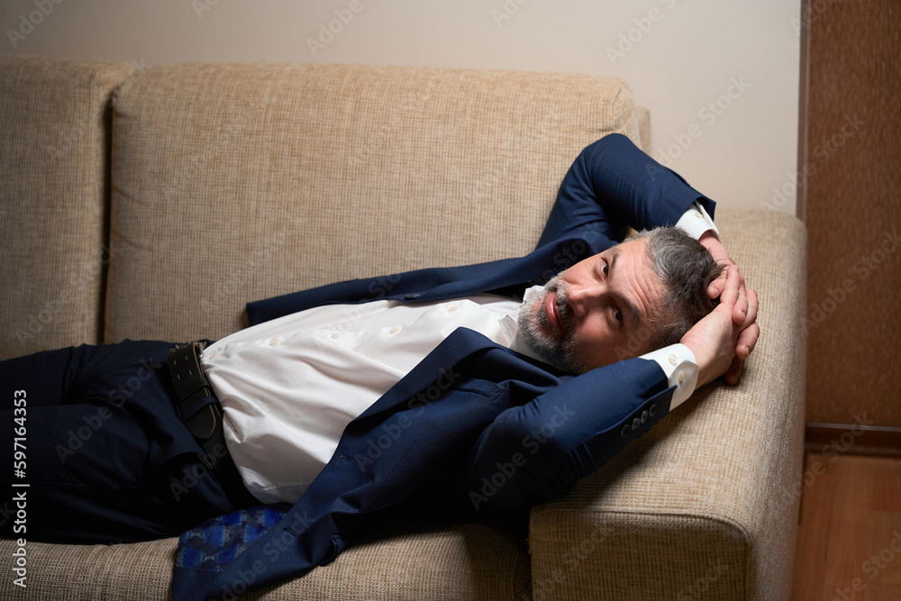 Close up photo of male resting on sofa