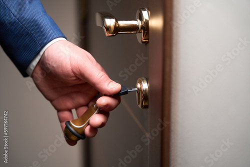 Man opening the door in the hotel room
