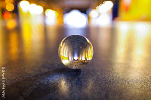 A lens ball on the floor nighttime scene in low light, shallow dept of field and selective focus. © Orange