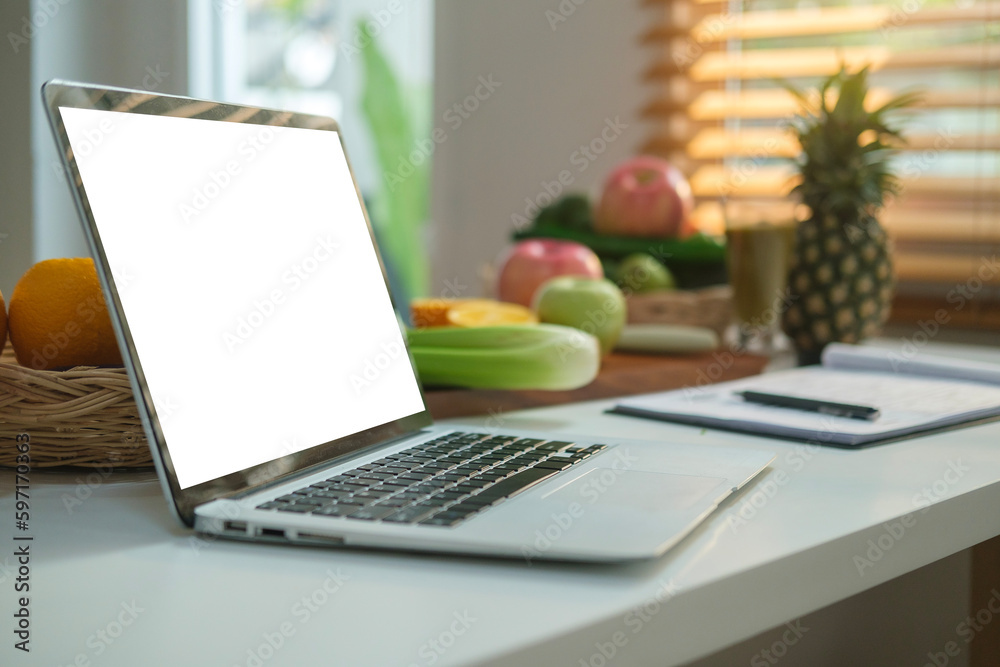 Laptop computer with fresh vegetables on white table. Dieting and healthy nutrition concept. Laptop computer with fresh vegetables on white table. Dieting and healthy nutrition concept.