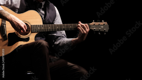 man playing guitar in the spotlight