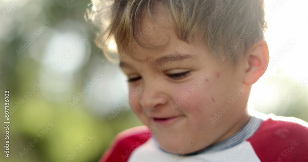 Toddler boy face opening mouth feeling joy and happy. Child portrait outdoors Toddler boy face opening mouth feeling joy and happy. Child portrait outdoors
