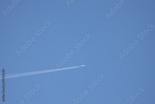 plane in the sky leaving its wake