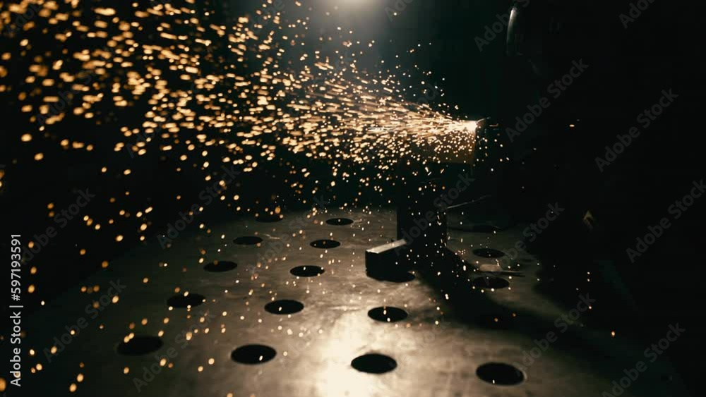 Slow motion: laser cutting, working with a metal workpiece with sparks in a factory. Metalworking, machining, industry, equipment, technology, production concept