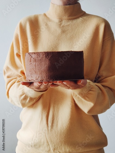person holding a chocolate cake (ID: 597198501)