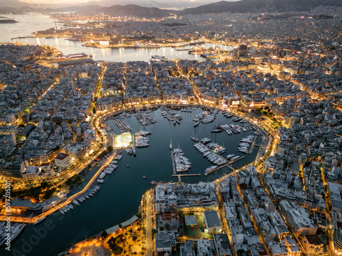 Aerial view of the illuminated Zea Marina in Piraeus, Athens, Greece, with lined up sailing boats and yachts during evening photo