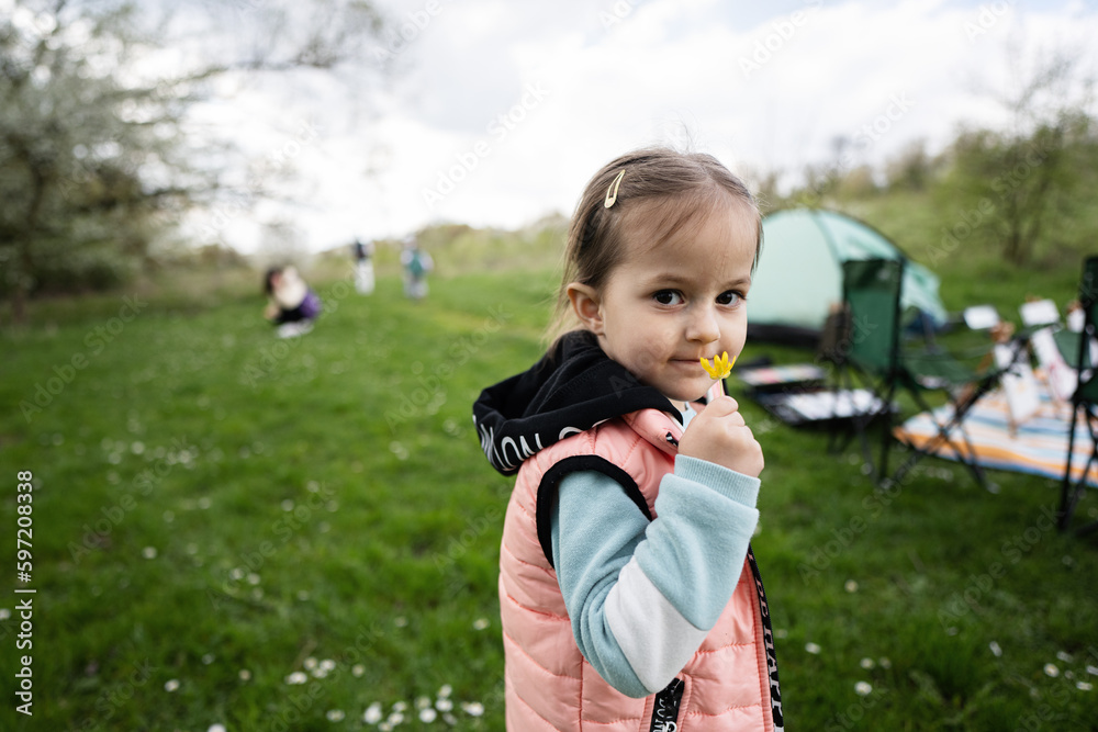 Baby girl sniffs a yellow flower on spring meadow. Baby girl sniffs a yellow flower on spring meadow.