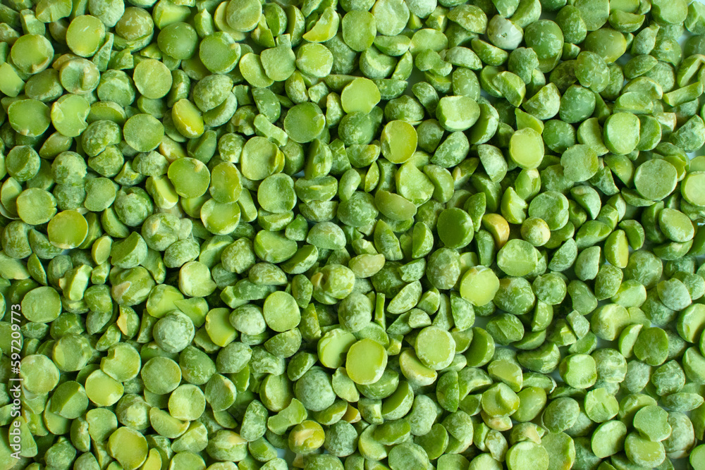 Poured dry green peas background. Raw organic split pea groat Poured dry green peas background. Raw organic split pea groat