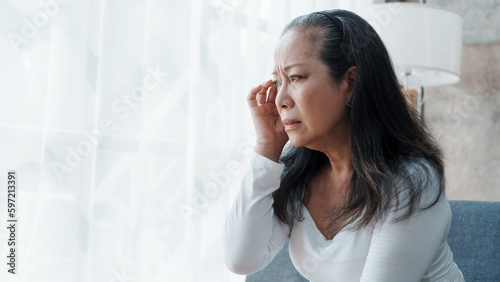 Mature woman feeling sad, asian elderly housewife anxiety depressed thinking senior chinese ethnicity. © makibestphoto