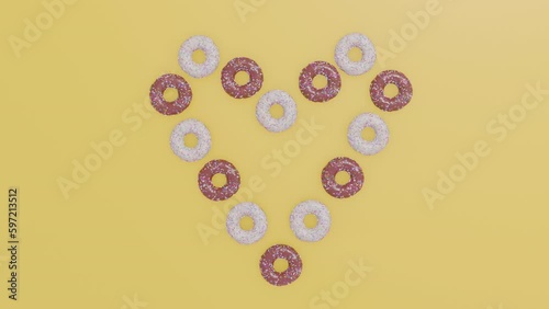 Donuts forming a heart. Top-down view and yellow background.