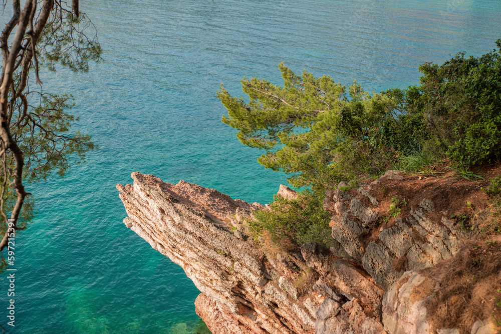View of the rocks and the blue Adriatic Sea in Budva in the queen park