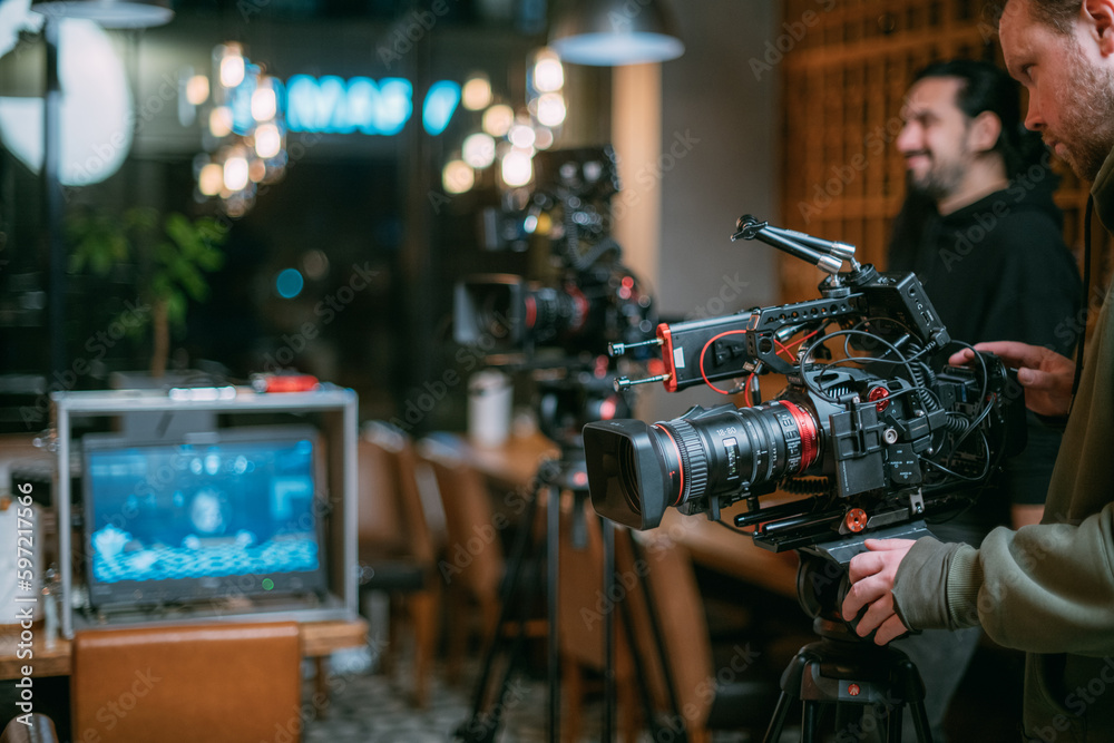 Professional cinema and video camera on the set. Shooting shift, lighting fixtures, shooting equipment and the team. Professional cinema and video camera on the set. Shooting shift, lighting fixtures, shooting equipment and the team.