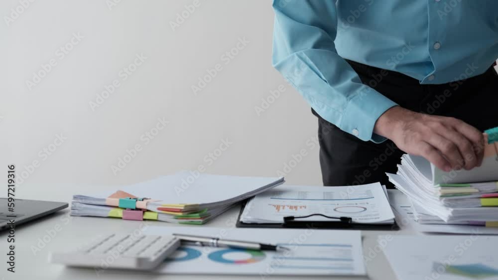 Close up view of businessman working with stack of document papers on the table.