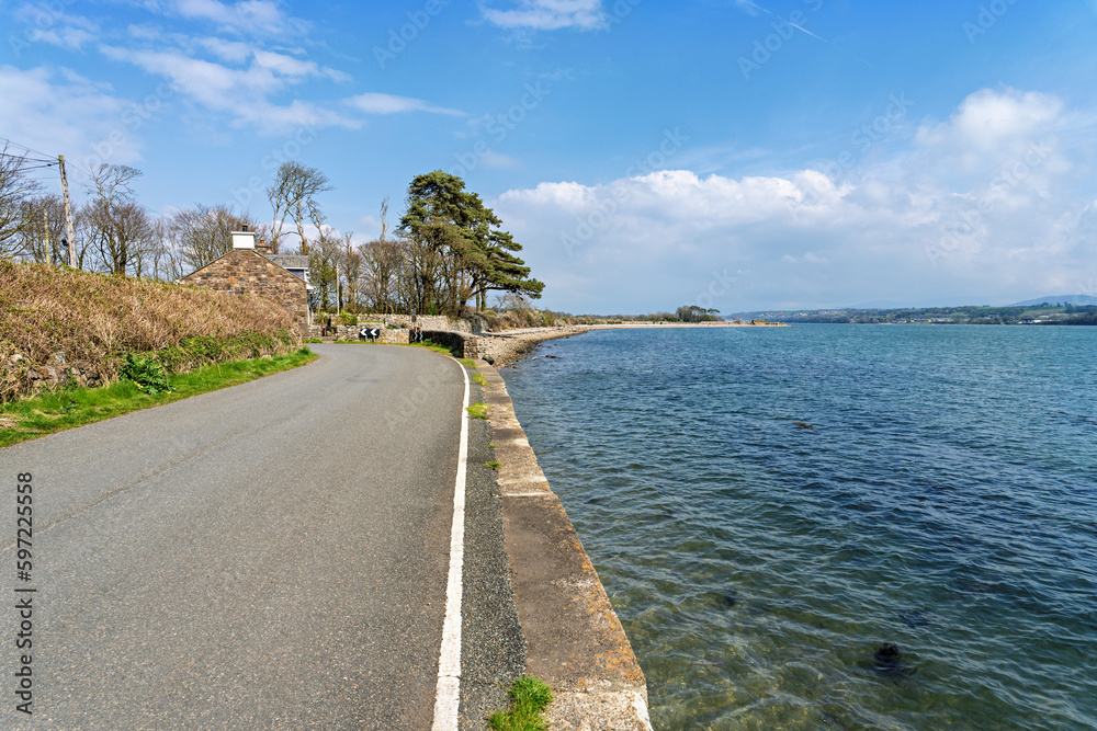 Tranquil coastal road along side the Menai Straits Anglesey North Wales UK