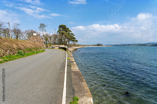 Tranquil coastal road along side the Menai Straits Anglesey North Wales UK