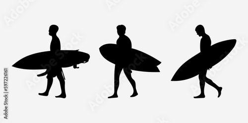 The silhouette of surfers with their boards.
