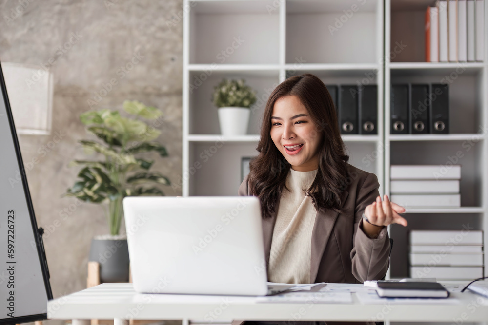 Business woman using calculator for do math finance on wooden desk in office and business working background, tax, accounting, statistics and analytic research concept.. Business woman using calculator for do math finance on wooden desk in office and business working background, tax, accounting, statistics and analytic research concept..