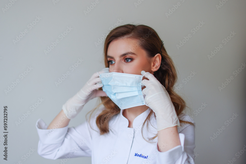 young beautiful woman showing how to wear a medical mask young beautiful woman showing how to wear a medical mask