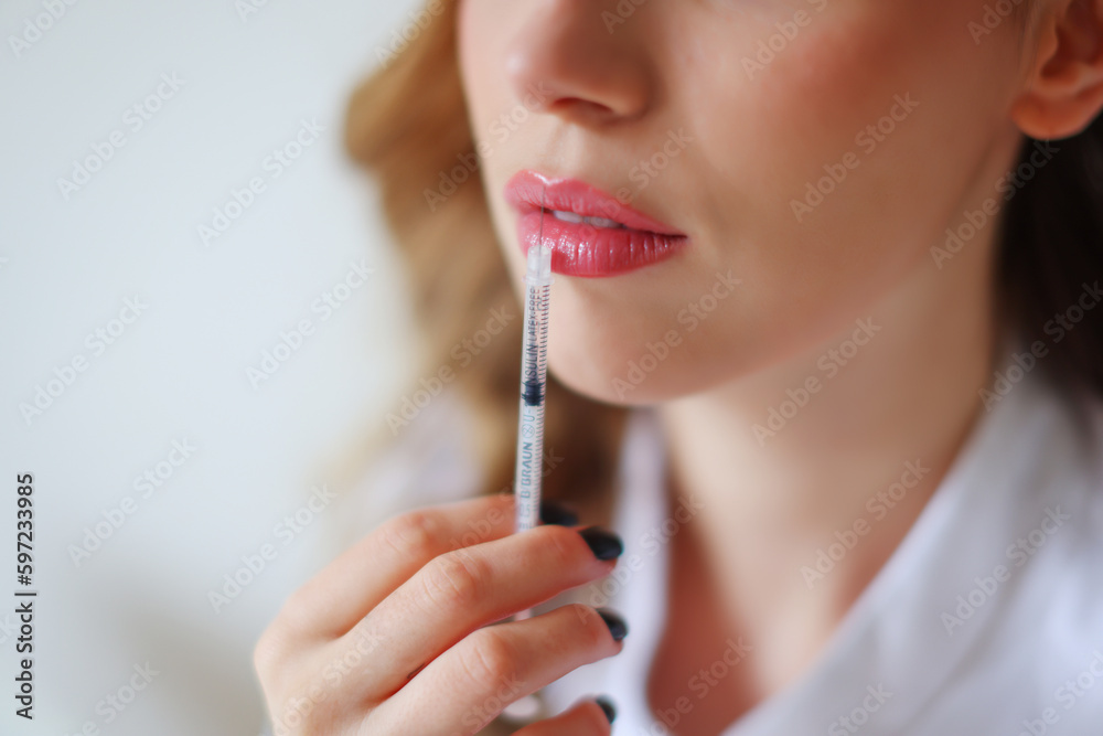 Injection of beauty, cosmetician's hands with a syringe, soft woman's skin 