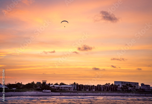 Shining sky over the ocean in the evening at sunset. Paragliding. The beauty of nature. Travel, tourism, recreation.