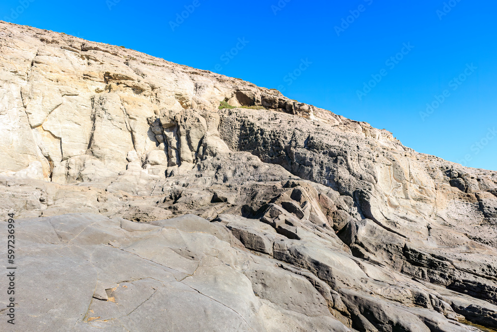 unusual rock formations of the volcanic cliff on Cala Sapone beach, quartz-trachitic ignimbrites.