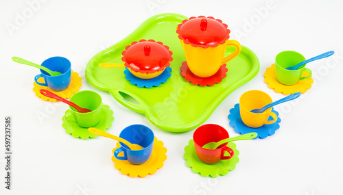 Children's toy multi-colored plastic tableware on a white background.