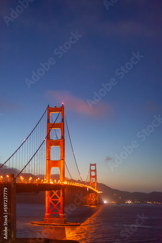 cars at golden gate bridge in the evening under blue sky