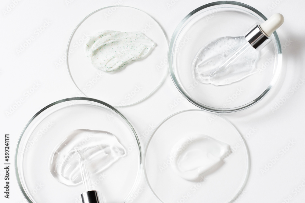 Drops and smears of cosmetics, pipette and petri dish. Drops of liquid transparent gel with bubbles on a white background. Cosmetic background. Drops and smears of cosmetics, pipette and petri dish. Drops of liquid transparent gel with bubbles on a white background. Cosmetic background.