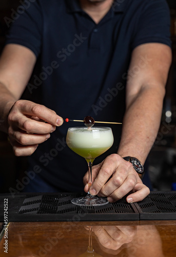 Alcohol cocktail on the bar. bartender prepares an alcoholic cocktail . delicious drink 