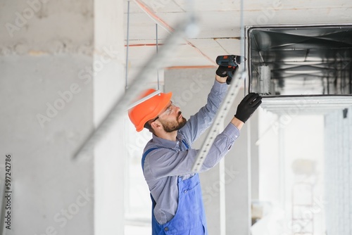 hvac engineer install heat recovery ventilation system for new house. copy space photo