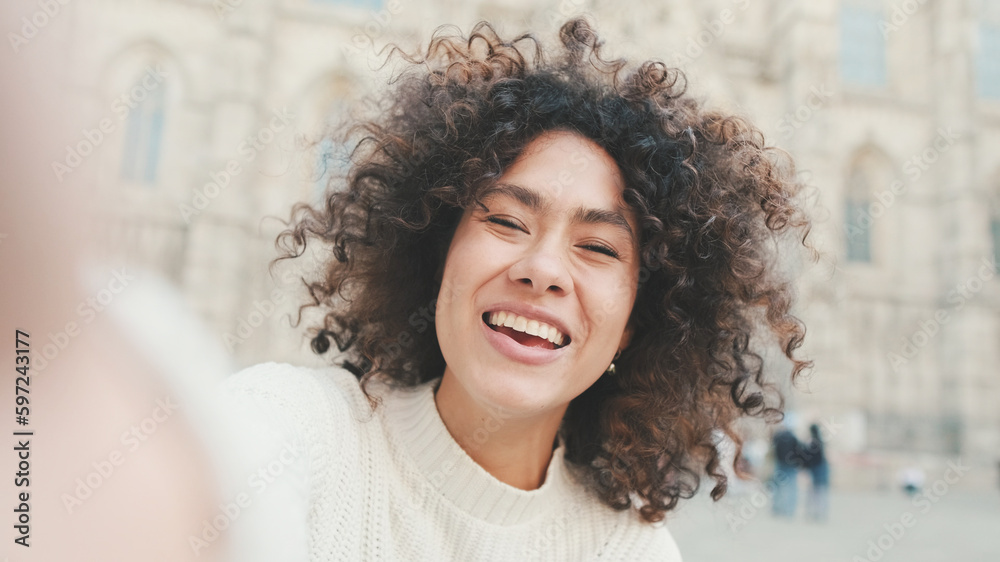 Close up, young woman is sitting down on a cell phone. Girl posing for a selfie on the old city background Close up, young woman is sitting down on a cell phone. Girl posing for a selfie on the old city background