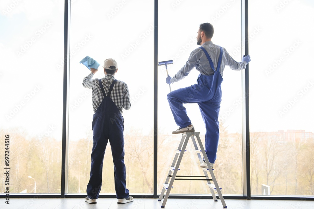 A man cleaning windows. cleaning team of men washes the windows