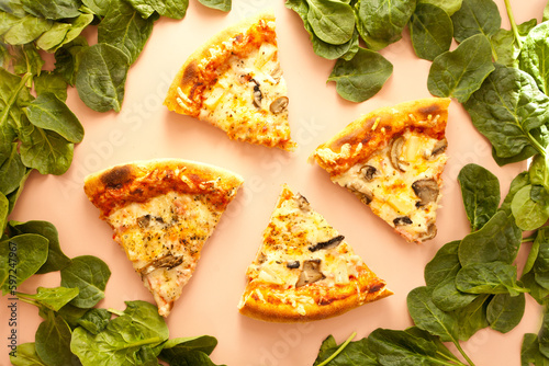 Sliced pizza. cheese on pink background. pizza slice top view. Italian traditional food with spinach