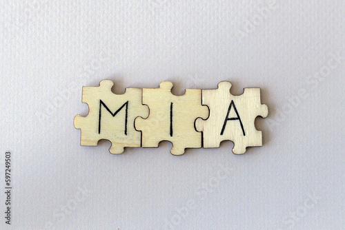The acronym MIA, which stands for Missing In Action. The letters written on the puzzles.