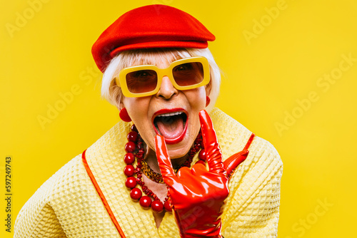 Cool and stylish senior old woman with fashionable clothes - Elderly funny female with stylish colorful dress portrait on isolated colored background