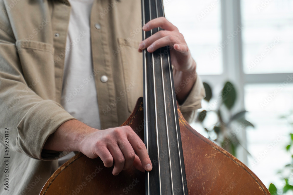 Double bass. Hands playing contrabass player musical instrument. Double bass. Hands playing contrabass player musical instrument.