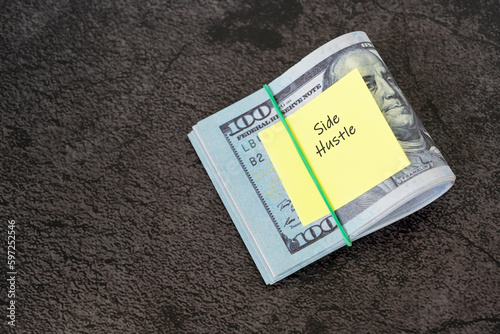 Financial bills and adhesive note with text - Side hustle photo