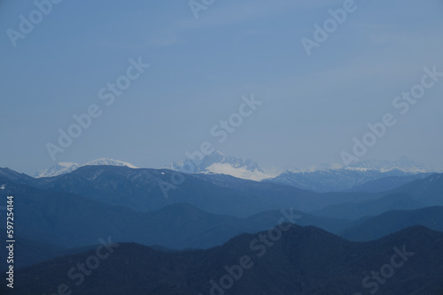 Minimalistic landscape , no people. View of snowy peak of Mount Fisht from afar. Main Caucasian ridge in reserve. Beautiful views of nature of Russia. Oshten and Psheho Su. © Ekaterina
