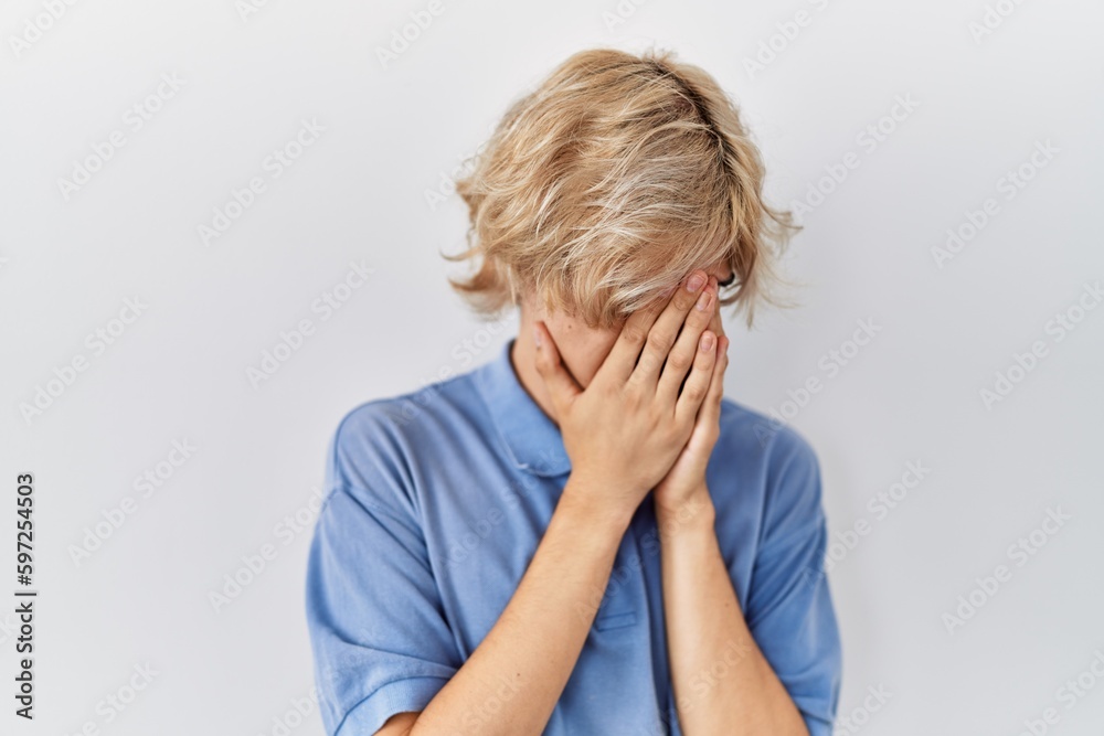 Young modern man standing over isolated background with sad expression covering face with hands while crying. depression concept. Young modern man standing over isolated background with sad expression covering face with hands while crying. depression concept.