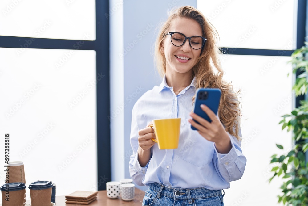 Young blonde woman business worker using smartphone drinking coffee at office Young blonde woman business worker using smartphone drinking coffee at office