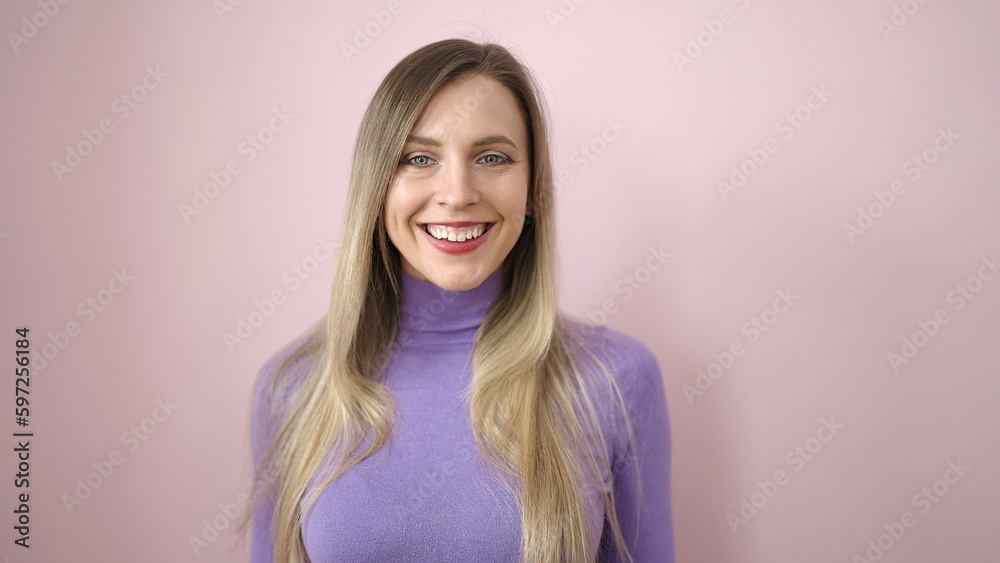 Young blonde woman smiling confident standing over isolated pink background Young blonde woman smiling confident standing over isolated pink background