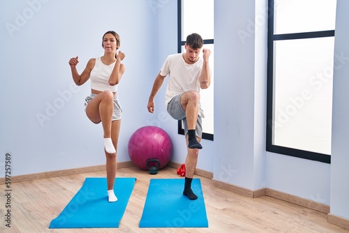Young man and woman couple training at sport center