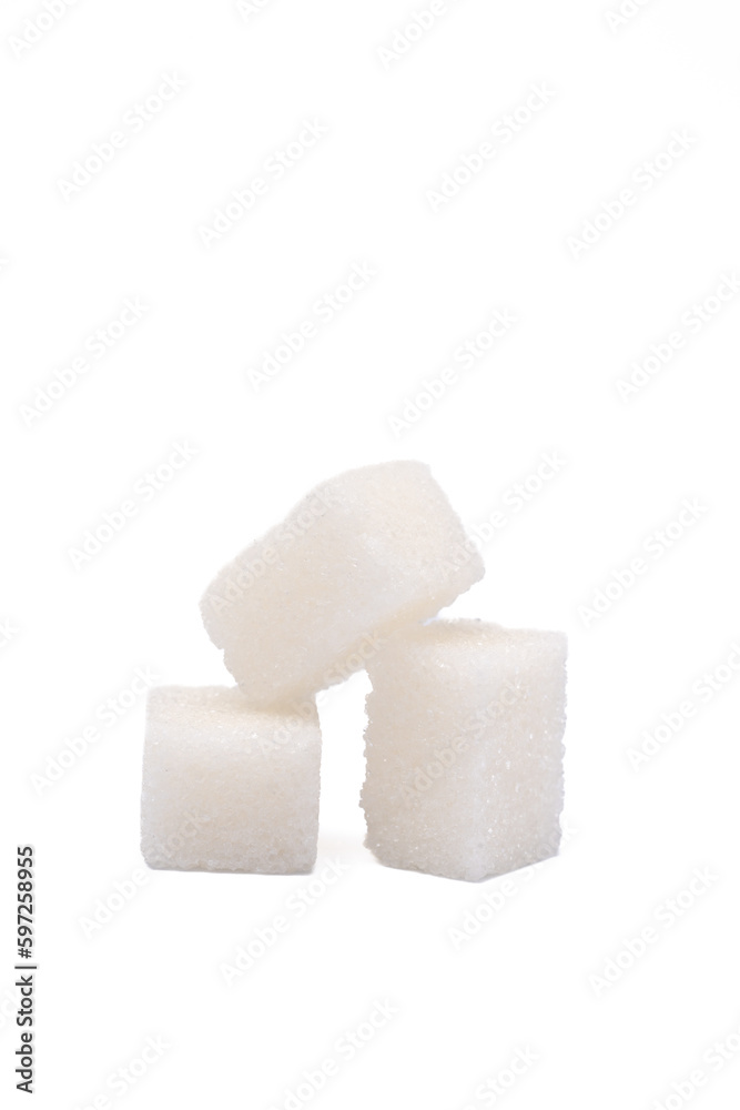 White sugar cubes on the white background