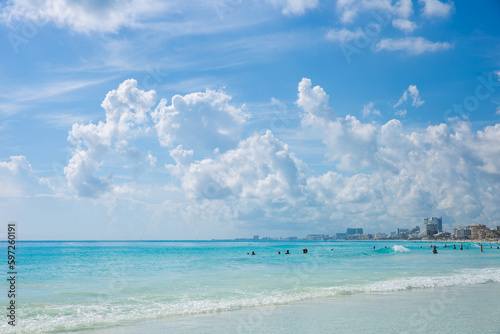 Beautiful sandy beach with people relaxing in a resort in Cancun  Mexico. Summer and sunshine.